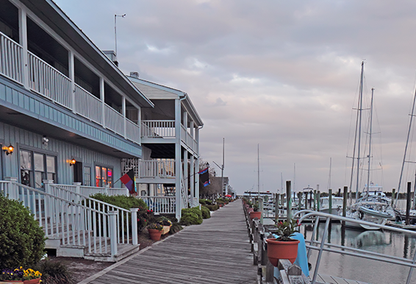 Sunset over buildings, boats and the docks on Taylor Creek off of Front Street in Beaufort, the third-oldest town in North Carolina